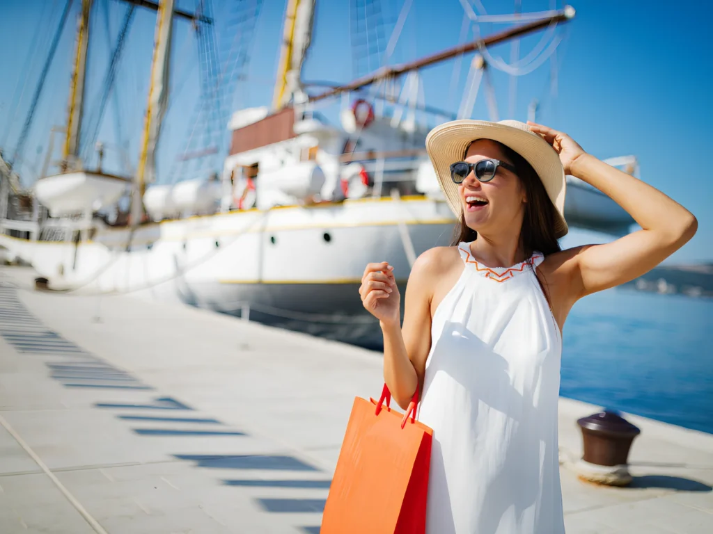 Image of a woman with a yacht in the background.