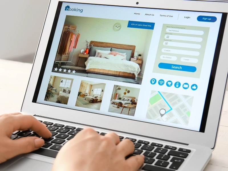 Image of a person booking a rental property online.