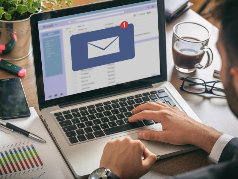 Image of a person sending an email.