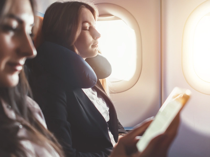 Image of young adults taking a trip on a plane.